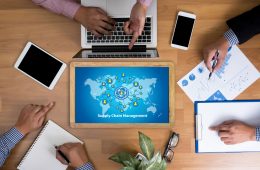 Desk with laptop, phones and business documents.
