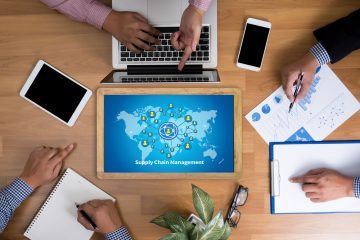 Desk with laptop, phones and business documents.