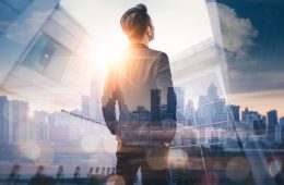 Image of man looking out across city skyline