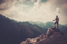 Man standing on top of mountain