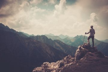 Man standing on top of mountain