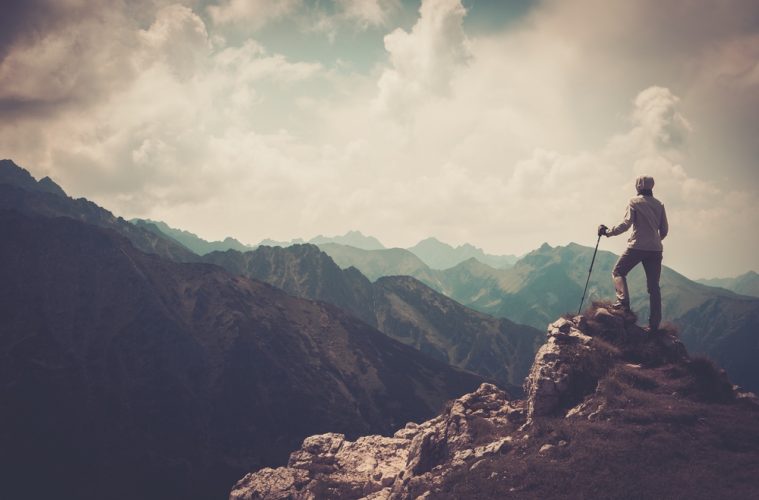 Man standing on top of mountain