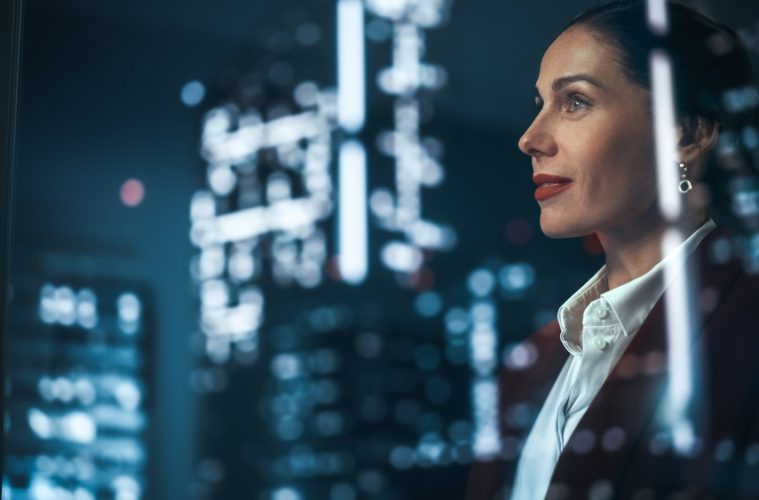 Business women in office looking out of window