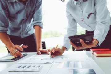 Businessmen working over a desk