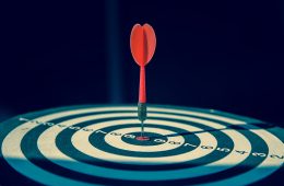 Forecast accuracy concept with dartboard